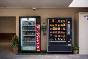 two soda machines are next to each other at San Francisco Inn in San Francisco