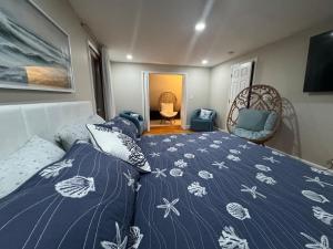 a bedroom with a bed with a blue comforter at Serene waterfront getaway in Mashpee