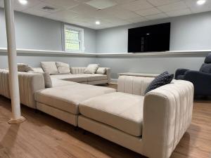 a waiting room with couches and a flat screen tv at Serene waterfront getaway in Mashpee