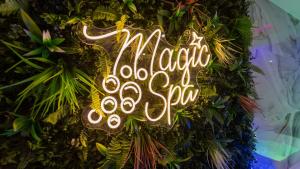 a neon sign that says magic word stop on a wreath at MagicSpa Gold in Chilly-Mazarin