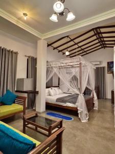 a bedroom with a bed with a canopy at Villa SeaLoom in Galle