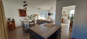 a kitchen and living room with a table and a couch at T3 indépendant Villa Heas in Argelès-Gazost