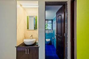 a bathroom with a sink and a toilet at Celeste holiday homes in Calangute +25 photos