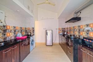 a large kitchen with a refrigerator in the middle at Celeste holiday homes in Calangute