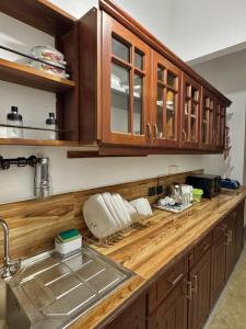 a kitchen counter with wooden cabinets and a sink at Villa SeaLoom in Galle +18 photos