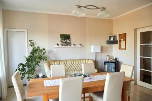 a dining room with a wooden table and chairs at Tompos Vendégház és pince in Villány
