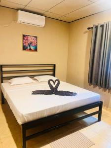 a bedroom with a bed with a bow on it at Hiri Hideout in Dickwella