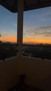 a sunset seen through two windows in a room at Villa SeaLoom in Galle