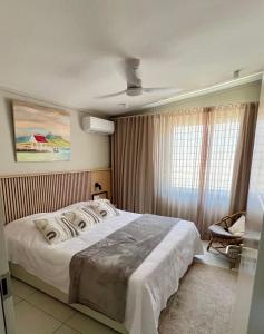 a bedroom with a large bed and a ceiling at Turquoise Bay Beach Apartments Trou d'Eau Douce in Trou d'Eau Douce +49 photos