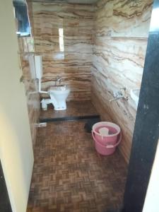 a bathroom with a sink and a toilet at Golden Oriole Homestay in Srīvardhan