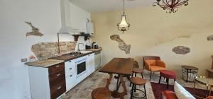 a kitchen with a counter and a table and chairs at Villa Colli in Picciano