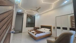 a bedroom with a bed and a ceiling fan at Greenwood Resort in Dhamni
