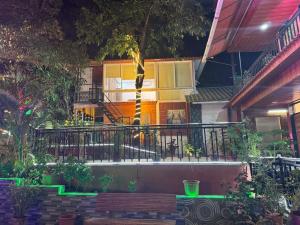 a building with a flag on a balcony at night at Greenwood Resort in Dhamni