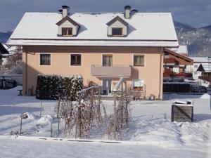 a house with a snow covered roof in the snow at Ferienwohnung Fill in Bad Häring +5 photos
