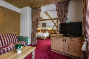 Televízia a/alebo spoločenská miestnosť v ubytovaní Hotel Gran Ciasa
