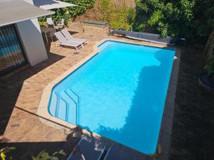 an overhead view of a blue swimming pool at 5 Rembrandt Guesthouse in Somerset West +9 photos
