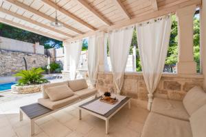 a living room with a couch and a table at Villa Aries in Supetar