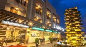 un edificio con una pila di cibo di fronte di L Square Hotel a Suizo