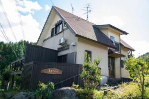 a house with a black fence in front of it at 日田天ヶ瀬の源泉掛け流し温泉付き貸別荘 5名様まで同料金 in Hita