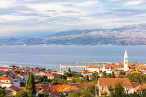 a view of a town with the water and mountains at Villa Aries in Supetar