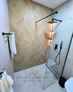 a shower with a glass door in a bathroom at Markowicz Alpine House in Szaflary +38 photos