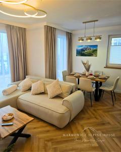 a living room with a couch and a table at Markowicz Alpine House in Szaflary