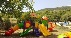a childrens playground with a colorful play equipment at Hotel Elit Palace and SPA in Balchik