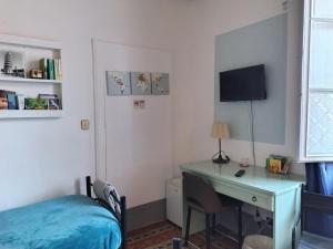 a bedroom with a desk and a bed and a desk with a computer at "LA MAISON DEL CORSO" Hospitality in Pisa