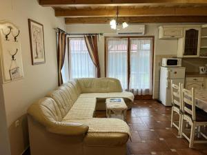 a living room with a couch and a table at Tölgyfa Apartman in Balatonkeresztúr +6 photos