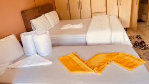 two beds in a room with towels on them at Star in Katima Mulilo +1 photo