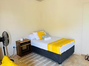 a small bedroom with a bed and a fan at Star in Katima Mulilo