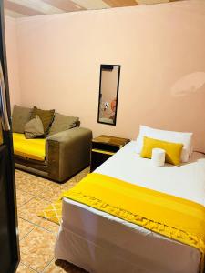 a bedroom with a bed and a couch at Star in Katima Mulilo