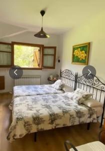 a bedroom with a bed and a window at Habitació Doble Era de Ferro in Erill la Vall