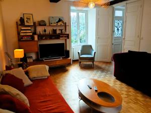 a living room with a couch and a coffee table at Villa Simone - 200m de la Plage in Les Sables-d'Olonne