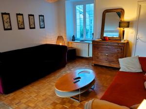 a living room with a couch and a table at Villa Simone - 200m de la Plage in Les Sables-d'Olonne