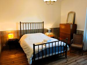 a bedroom with a bed and a dresser and a chair at Villa Simone - 200m de la Plage in Les Sables-d'Olonne