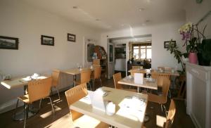 a restaurant with tables and chairs in a room at Atlantic Seafront in Brighton & Hove