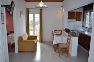 a kitchen and living room with a table and a chair at Digenis Studios in Lygia