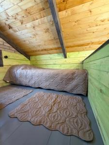 a bed in a room with a wooden ceiling at Arte Jermuk #3 in Jermuk