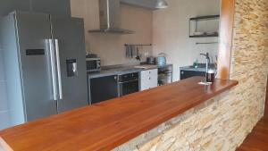 a kitchen with a wooden counter top in a kitchen at Ameli House By PECA in Silleda +25 photos
