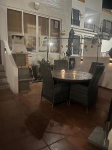 a dining room with a wooden table and chairs at Casa Sol Vistabella Golf Resort in Orihuela
