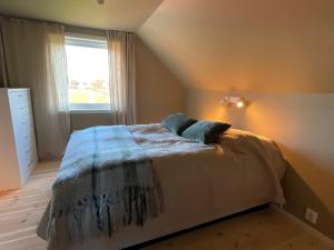 a bedroom with a bed with two pillows on it at Lofoten Seaside House in Offersøya