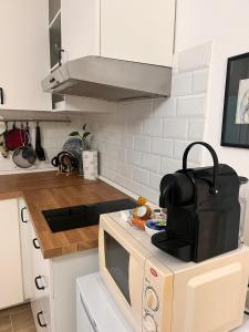 a kitchen with a microwave and a counter top at Monolocale Corbetta centro - House lab Milan in Corbetta +5 photos