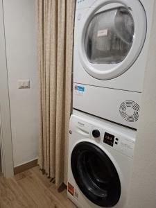a washing machine and a dryer in a room at Monolocale Corbetta centro - House lab Milan in Corbetta