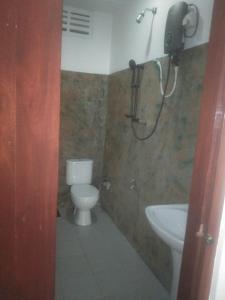 a bathroom with a toilet and a sink at Jayasri in Hikkaduwa