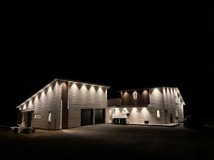 a barn at night with lights on it at Apartment in Målselv in Björklid +5 photos