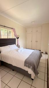 a bedroom with a large bed in a room at Gaxela Space in Pietermaritzburg