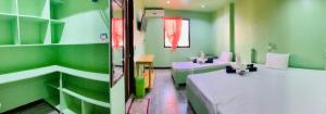 a hospital room with two beds and green walls at Coron Sanho Pension in Coron