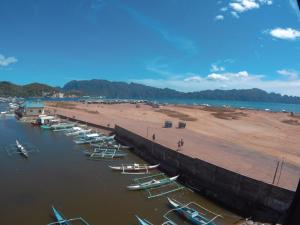 a group of boats in the water next to a beach at Coron Sanho Pension in Coron