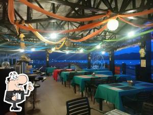 a restaurant with tables and chairs with blue tables at Coron Sanho Pension in Coron